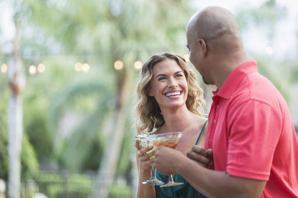 A couple cheers in an outdoor setting A couple cheers in an outdoor setting
